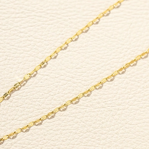 Detailed macro view of golden stainless steel lip chain with flat oval links for DIY jewelry