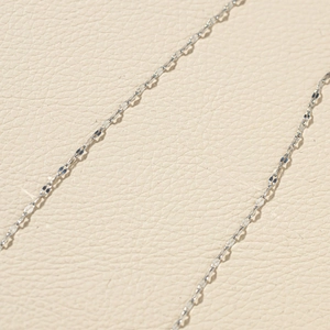 Macro shot of silver titanium steel lip chain link showing fine metallic texture and details
