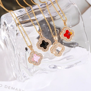 Detailed macro view of four leaf clover pendants with sparkling micro-pave crystals