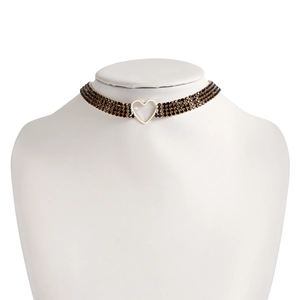 Close-up of triple-layer black rhinestone choker with a golden hollow heart pendant