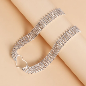 Detailed macro view of silver multi-layer rhinestone choker with hollow heart pendant