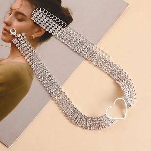 Detailed view of silver multi-row rhinestone chain necklace with hollow heart pendant