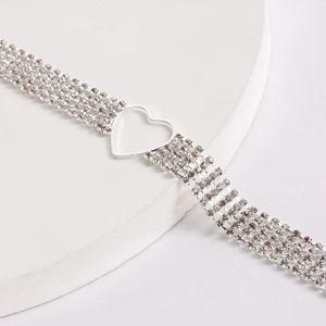 Detailed view of multilayer silver choker with rhinestone chains and hollow heart charm