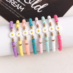Set of 8 bohemian colorful clay bead bracelets with daisy flower charms and gold accents