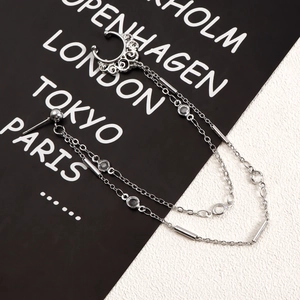Silver chain nose ring with hollow pattern and zircons on black and white background
