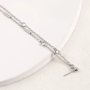 Macro detail of silver layered chain nose piercing jewelry with sparkling zircon accents