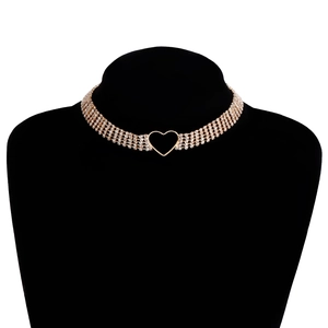 Macro shot of gold-tone choker necklace featuring multi-layered rhinestones and hollow heart