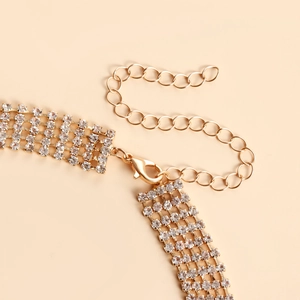 Detail of multi-row gold rhinestone necklace with adjustable lobster clasp and chain link