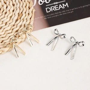 Elegant bow knot stud earrings in gold and silver finish with minimalist ribbon design