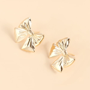 Detailed view of elegant gold bow earrings with a polished metallic finish and textured folds