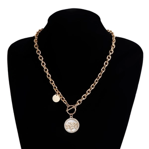 Detailed view of Tree of Life pendant with white shell inlay on golden OT buckle necklace