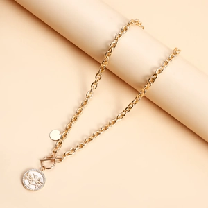 Detail of gold tree of life pendant with white rhinestones and OT toggle clasp closure