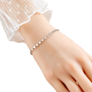 Elegant titanium steel clover bracelet with textured silver discs on a lace sleeve wrist