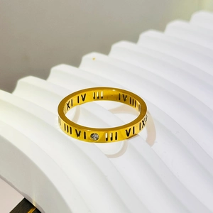 Golden titanium steel ring with black Roman numerals and a small zircon stone