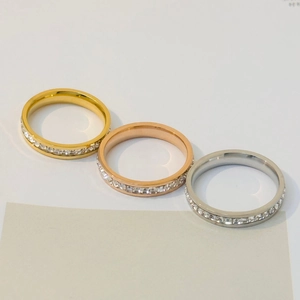 Detail view of gold, silver, and rose gold sparkling eternity rings with inlaid zircons