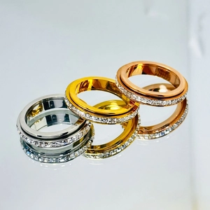 Detailed close-up of rotating anxiety rings in gold silver and rose gold with zircon