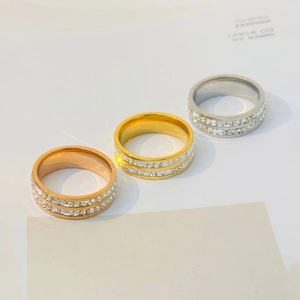 Detailed view of three polished rings in gold, silver, and rose gold with pavé-set stones