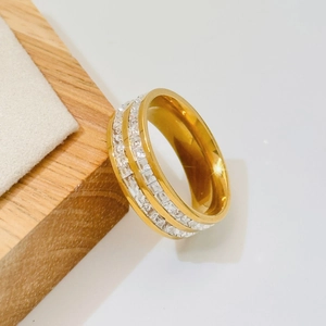 Minimalist gold wide ring with double row of square zircon stones on wooden prop