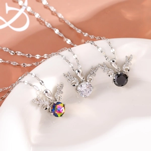 Close-up of elk horn pendant necklaces with colorful, clear, and black gemstones