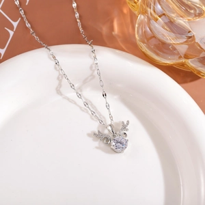 Detailed close-up of a silver elk antler necklace with a large round cubic zirconia