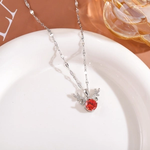 Detail of deer pendant with red zircon stone and small diamonds on silver chain necklace