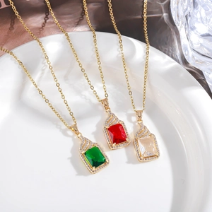 Close-up of hip hop square gemstone pendants in green, red, and clear with cz crystals