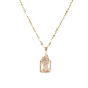 Macro shot of rectangular champagne zircon pendant with gold pavé crystal border