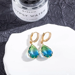 Detail of teardrop earrings with blue-green gradient crystals and gold micro-pave hooks