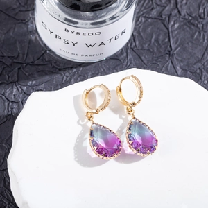 Detail of water drop earrings with purple gradient crystals and gold micro-pave setting