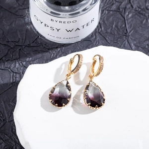 Detailed macro view of pear-cut gradient tourmaline earrings with micro-pave crystals
