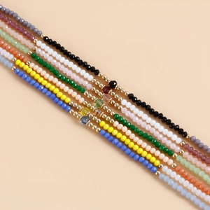Colorful spinel beaded eyewear chains with gold spacers shown in multiple vibrant colors