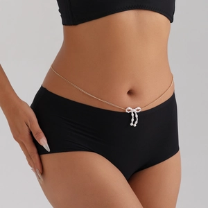 Chaîne de taille dorée élégante avec pendentif nœud en perles sur un mannequin femme