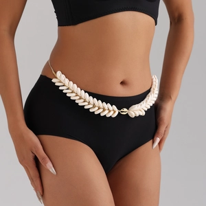Bohemian handmade natural seashell waist chain with gold beads on a model for beachwear