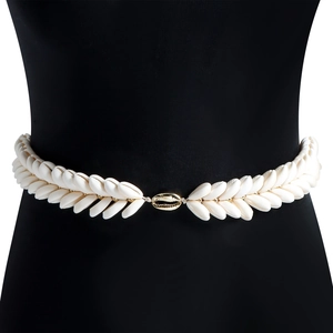 Detail of woven shell waist chain featuring a central gold metallic shell clasp