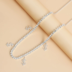 Detail of silver hip hop waist chain with iced-out dollar sign charms and rhinestone link
