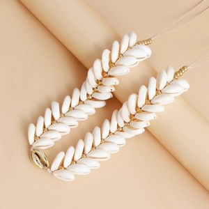 Handwoven natural cowrie shell waist chain with gold beads for summer beach styling
