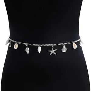 Close-up of silver waist chain with ocean shell and starfish charms on a black base