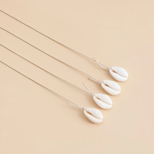 Detail view of handmade shell waist chains with natural white conch and braided cords