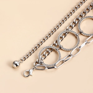Detail of silver multi-layer body chain with Greek key engraved rings and lobster clasp