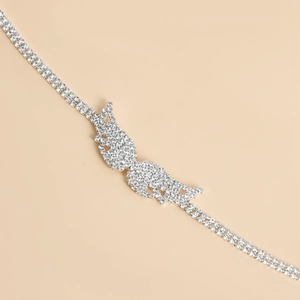 Macro shot of silver butterfly buckle and double-row rhinestone chain for bridal waist belts