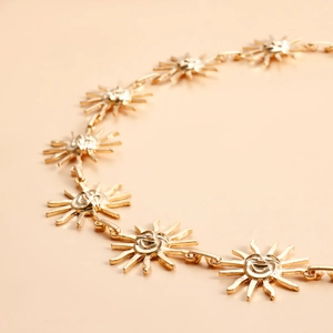 Golden sun smiley face pendant waist chain accessory shown in a stylized diagonal layout