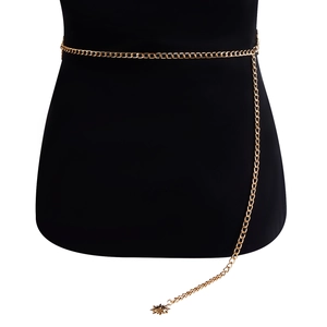Detail of golden metal waist chain featuring a delicate sun pendant on a black mannequin