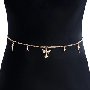 Detail of gold metal body chain featuring winged angel and star pendants on black base