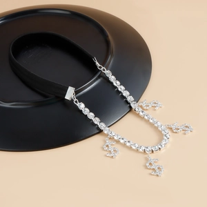 Detail view of sparkly rhinestone dollar sign pendants on a black elastic hip-hop leg chain