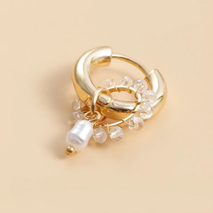 Detailed macro view of gold crystal and pearl beaded hoop earring with vintage aesthetic