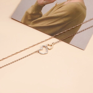 Détail de la chaîne de taille or rose avec pendentifs cœurs entrelacés et micro-zircons