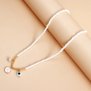 Bohemian white seed bead necklace with gold letter A, pearl and evil eye charms