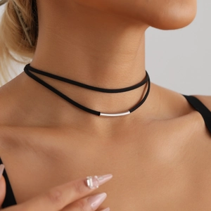 Close-up of minimalist double-layered black choker with a polished silver geometric tube