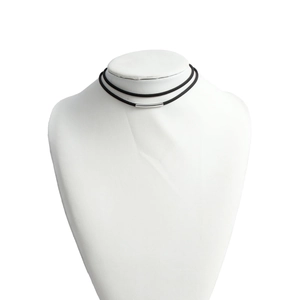 Detail of minimalist double-layered black cord necklace with silver metal tube on mannequin