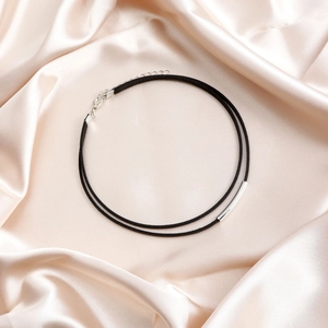Close-up of double-layer black velvet choker with silver tubes and lobster clasp
